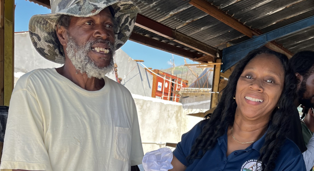 Staff delivering fisheries relief packages Jamaica fishers received at Belmont Fishing Beach.
